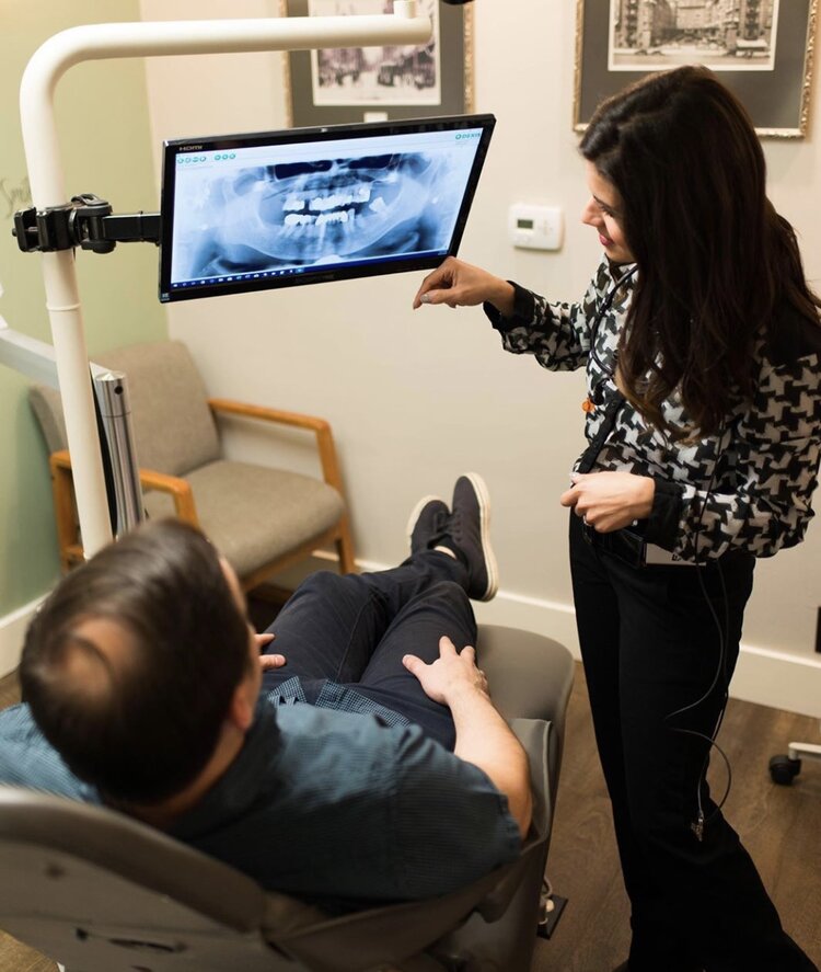dr khaki shows patient how laser dentistry works